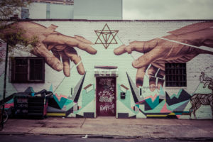 Graffiti of Michelangeloñ¥s God and Adamñ¥s hands in Williamsburg, Brooklyn, New York, USA Graffiti of Michelangeloñ¥s God and Adamñ¥s hands in Williamsburg, Brooklyn, New York, USA